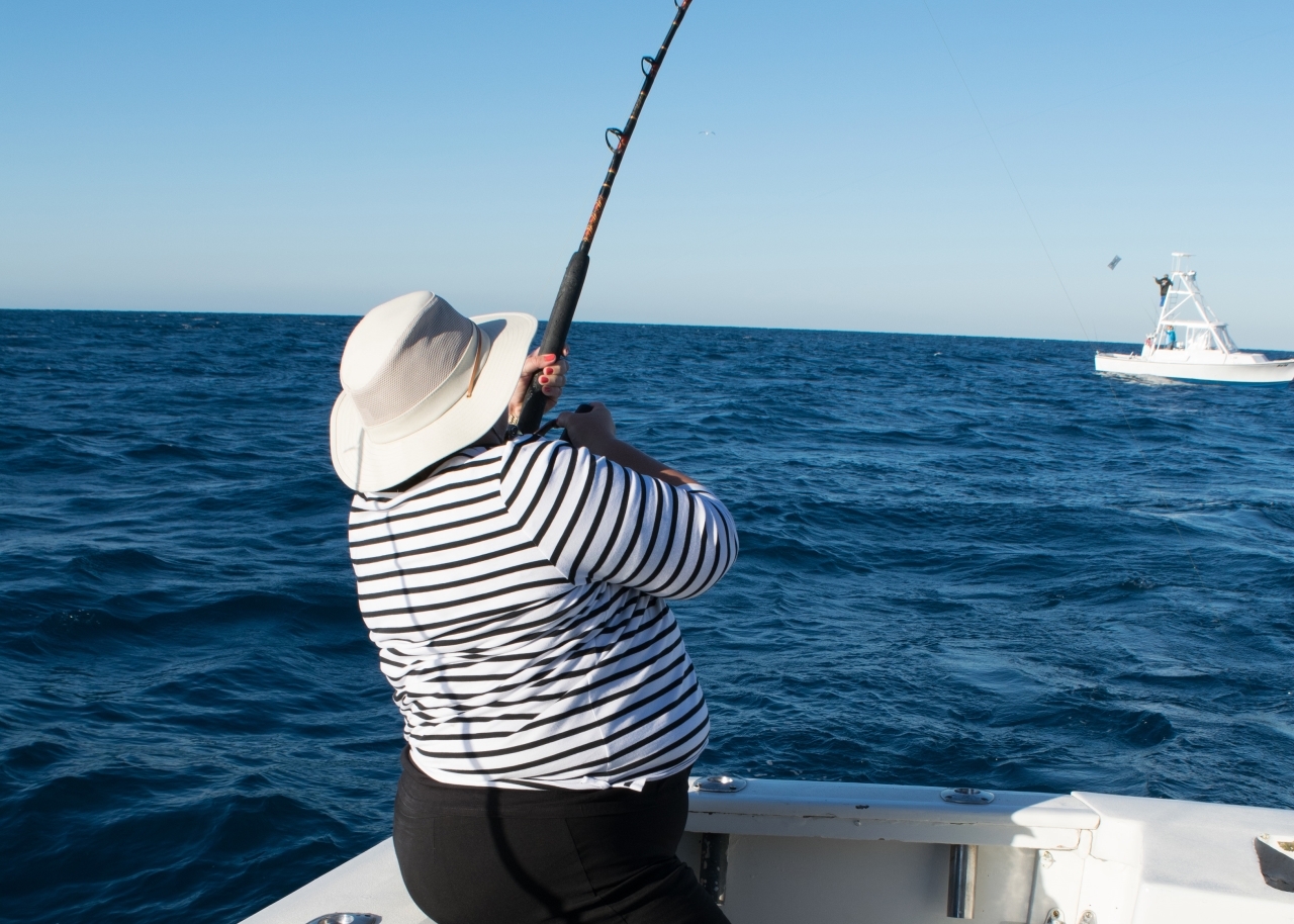 Woman fishing on boat